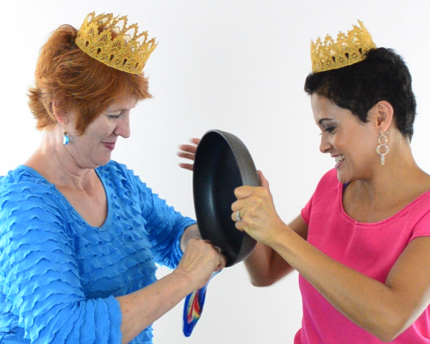 two people trying to stuff a frying pan into a balloon